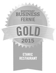 A grey icon of a winner's ribbon for the gold award for best ethnic restaurant of 2015 in the Kootenays is awarded to the Tandoor & Grill, the onsite restaurant at the Stanford Fernie Resort in BC.